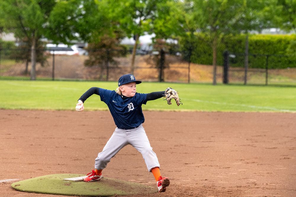 Baseball players fielding on a dirt infield during practice or game.