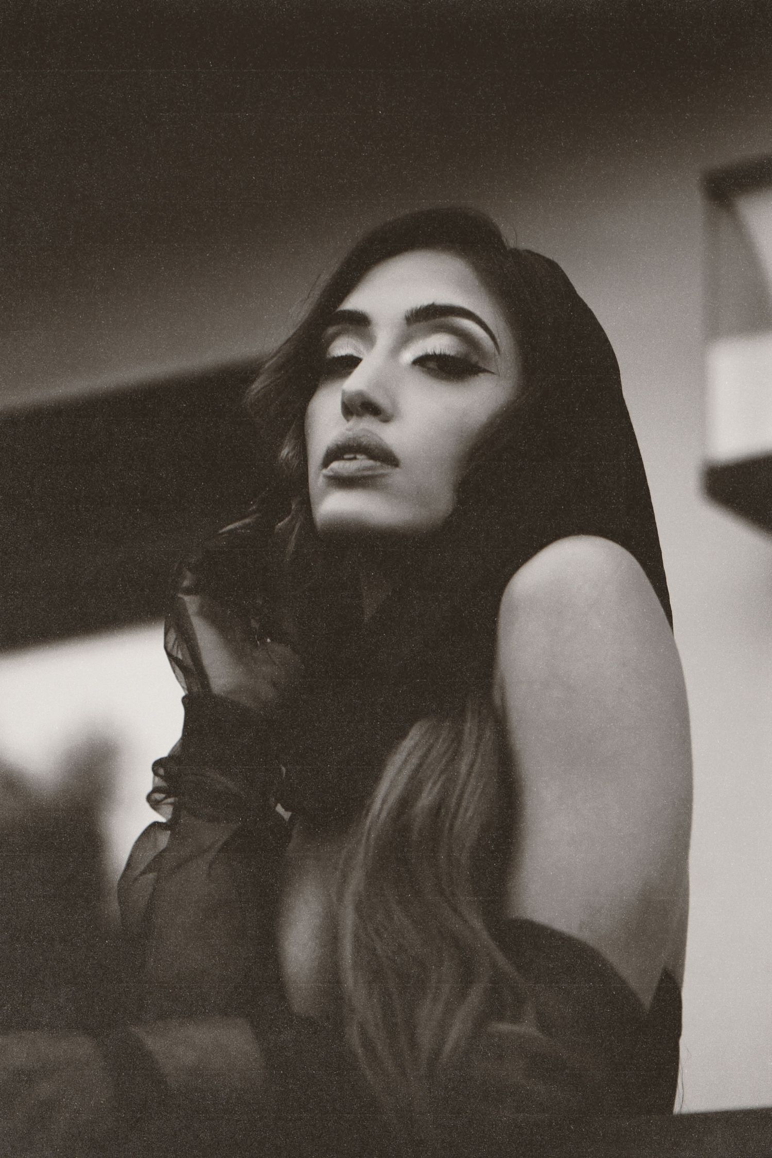 Artistic black and white photo series showing profile views of long dark hair against moody lighting and shadows.