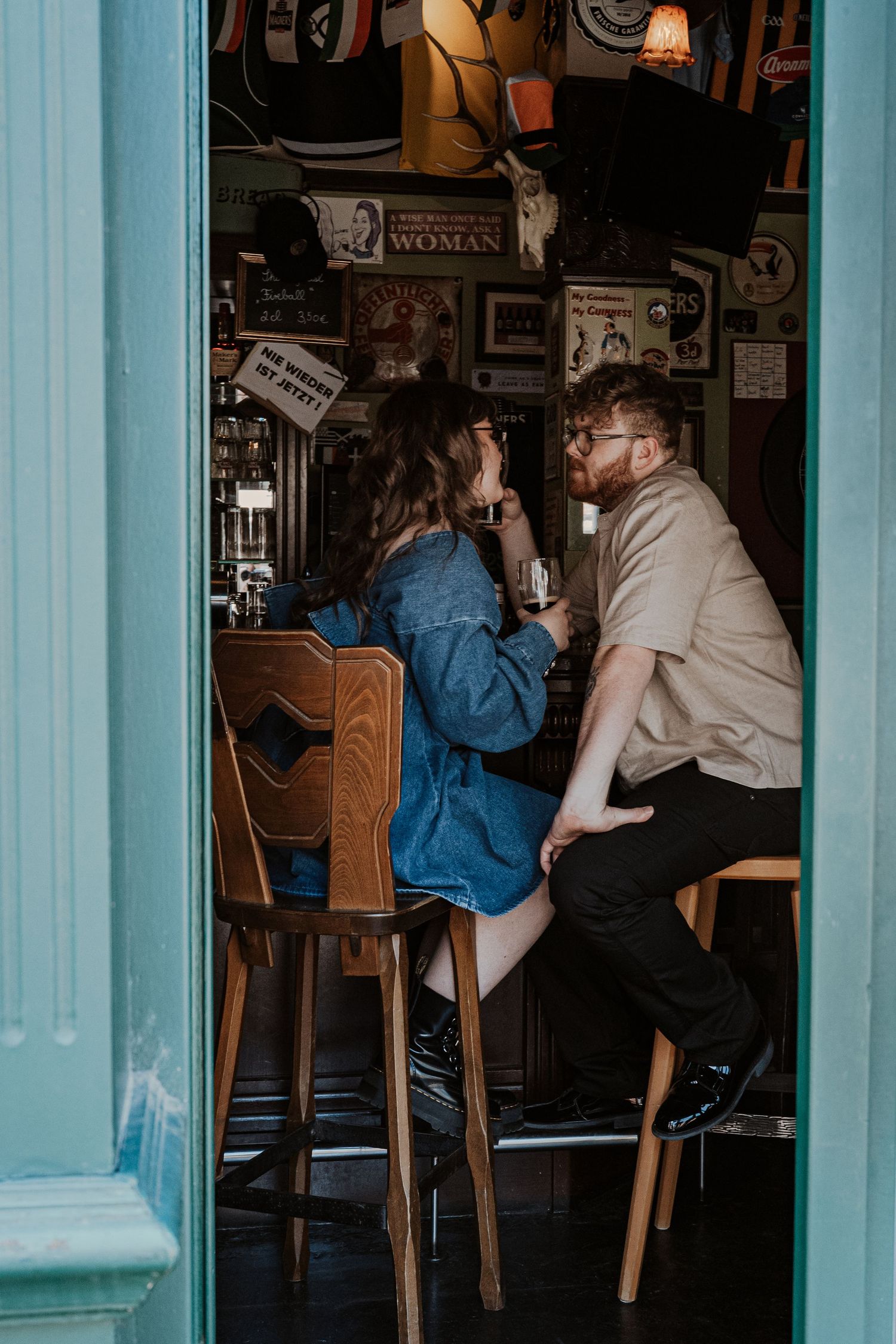 A black and white photo sequence shows a couple sharing a romantic kiss outdoors in a natural setting.