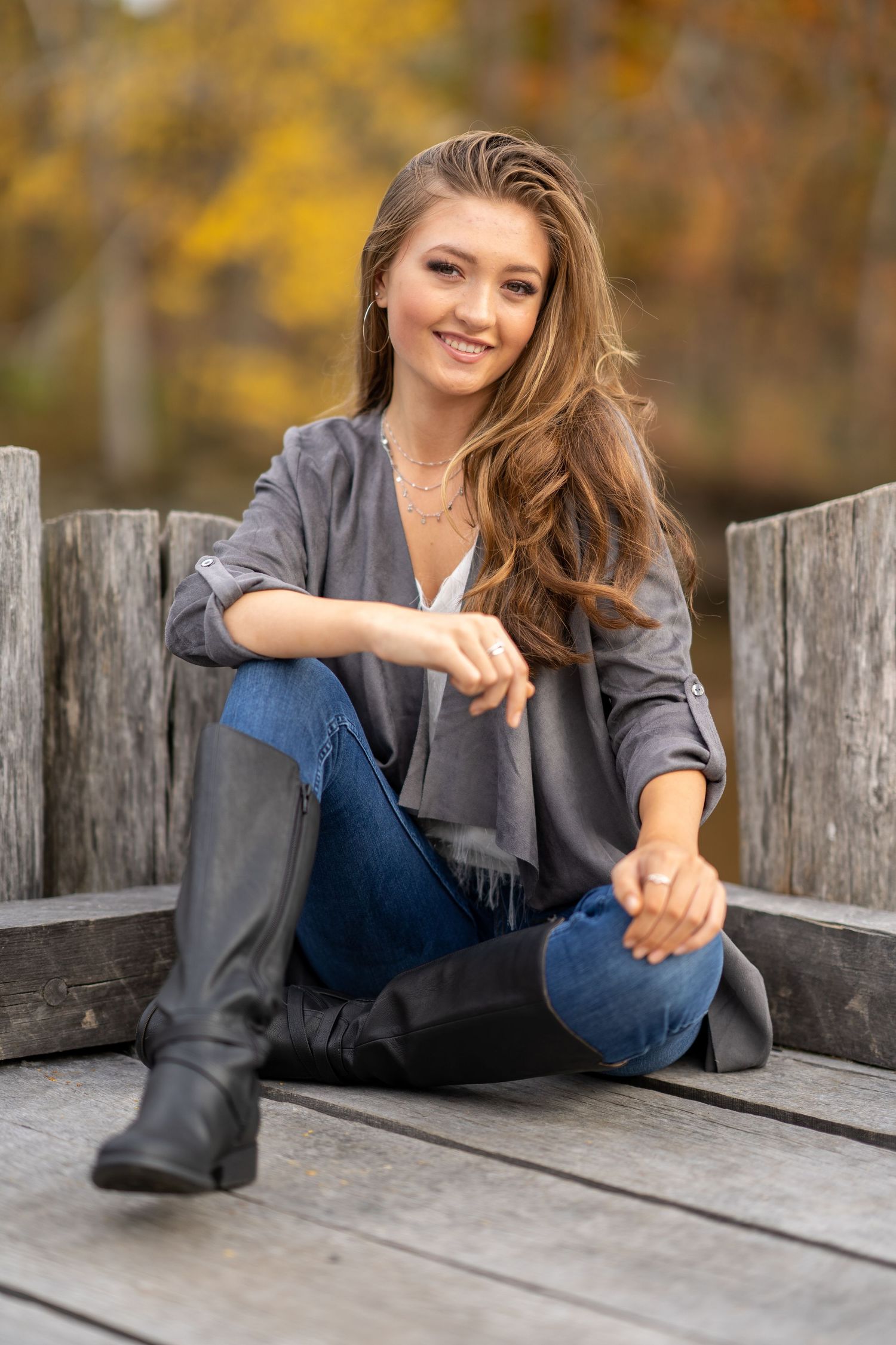 A series of casual outdoor portrait poses on a wooden bench during autumn with soft natural lighting.