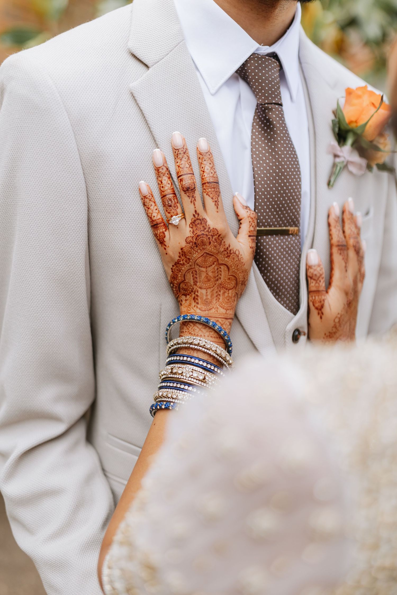 A couple in wedding attire shares a joyful dance moment during their celebration at a scenic outdoor venue. Thorpe Garden.