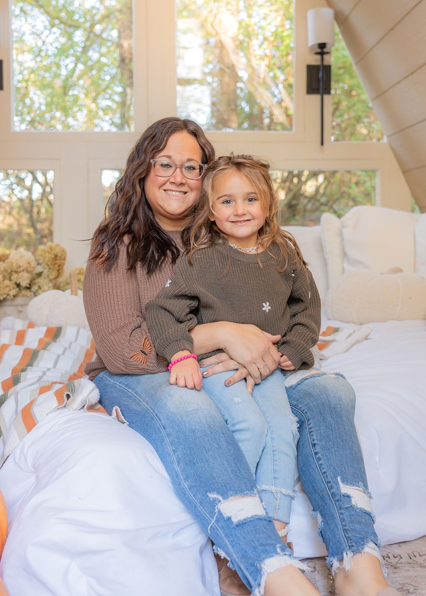 Casual indoor scene on a white couch with natural light streaming through windows.