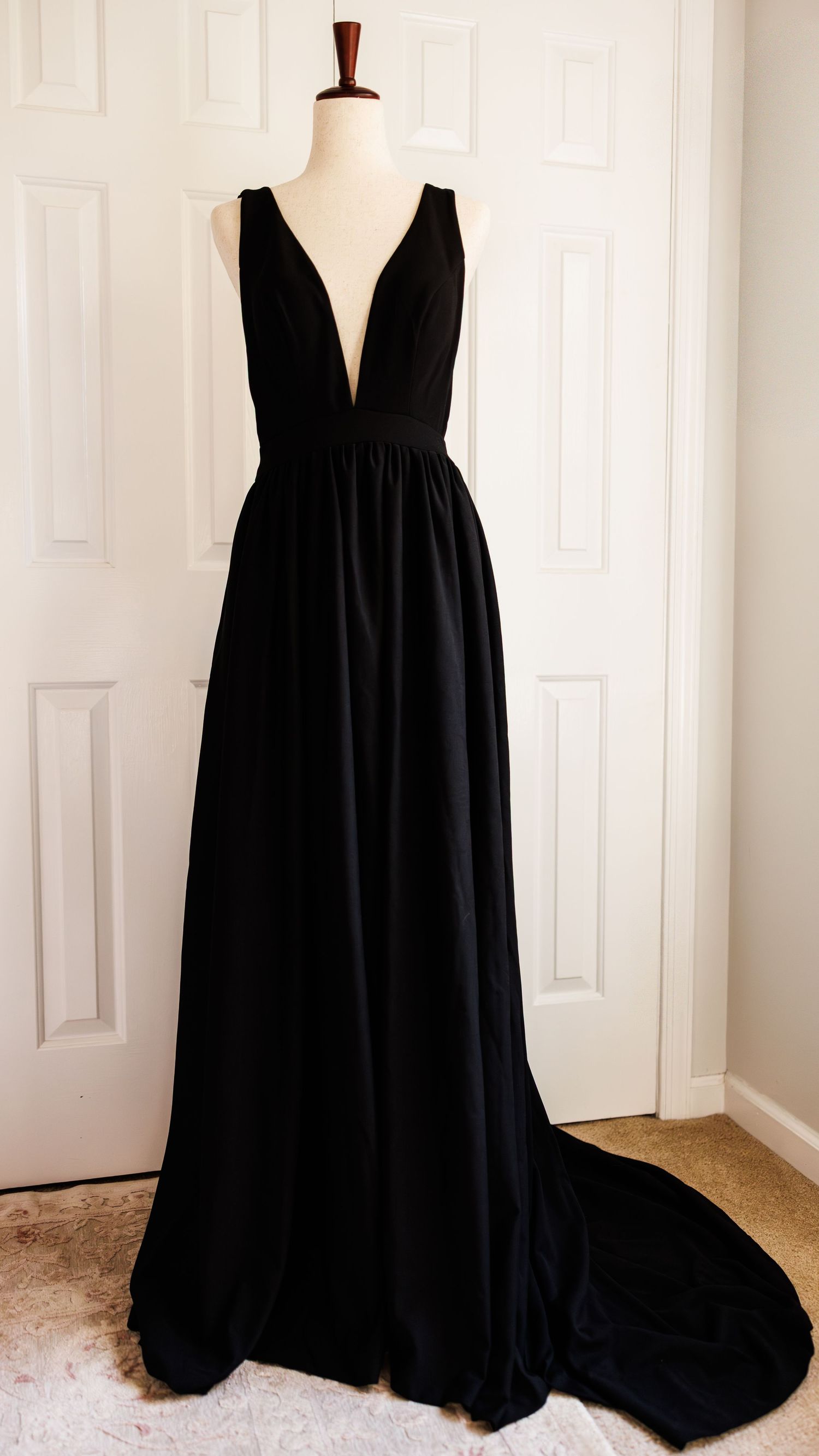 Vintage cream-colored maxi dress with puff sleeves and gathered neckline displayed on white mannequin against pale wall.