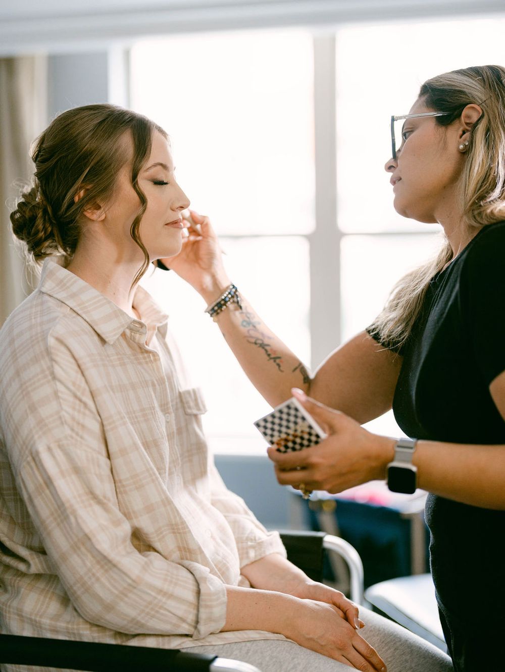 Behind-the-scenes preparation with makeup artists working on wedding day styling.