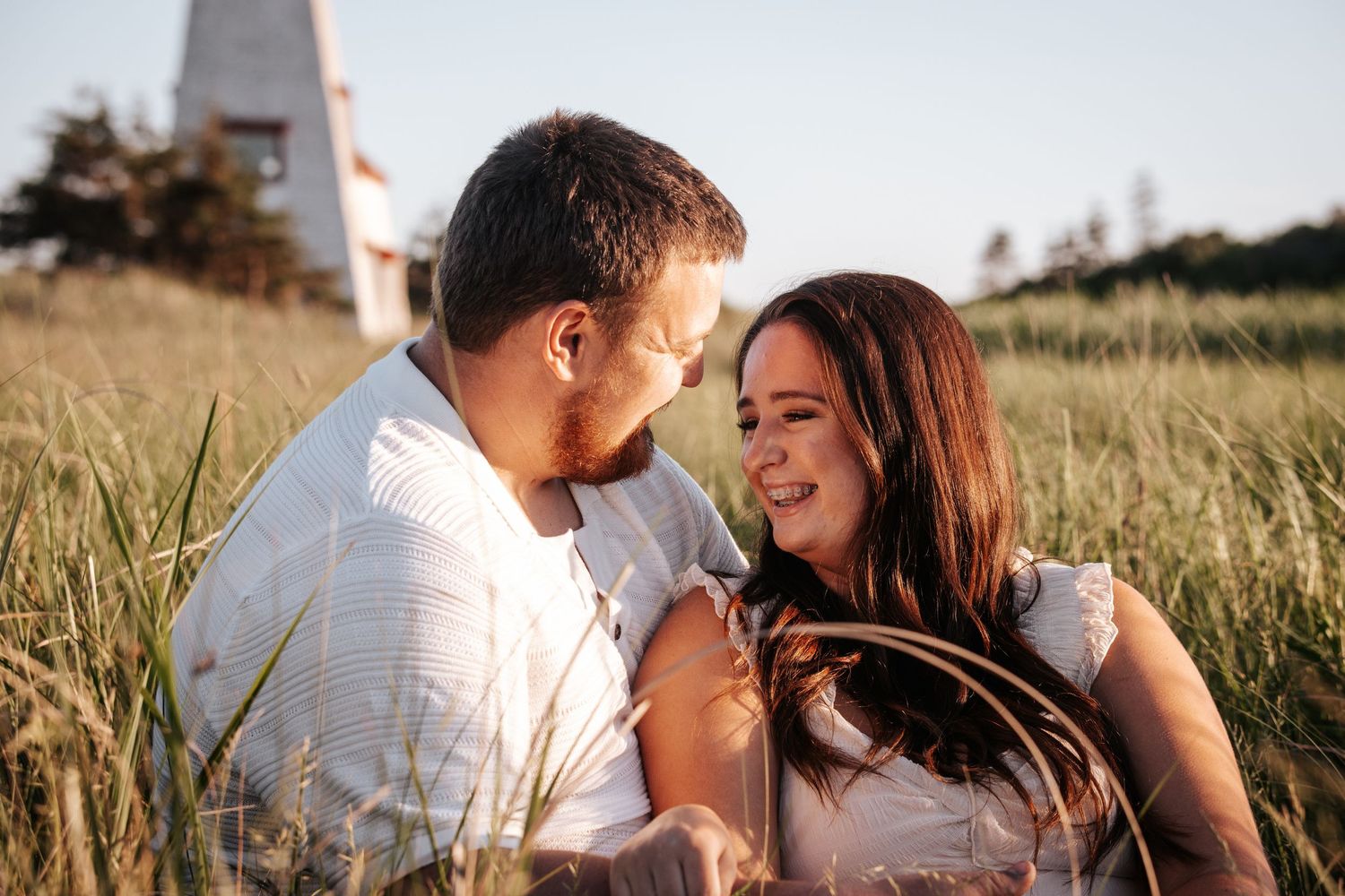 Couple sharing intimate moments in golden wheat field at sunset.
