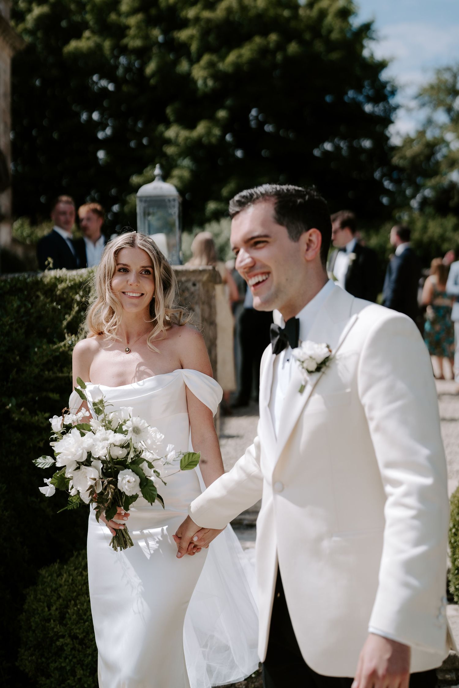 bride and groom walking through confetti tunnel at hasmwell house in bath