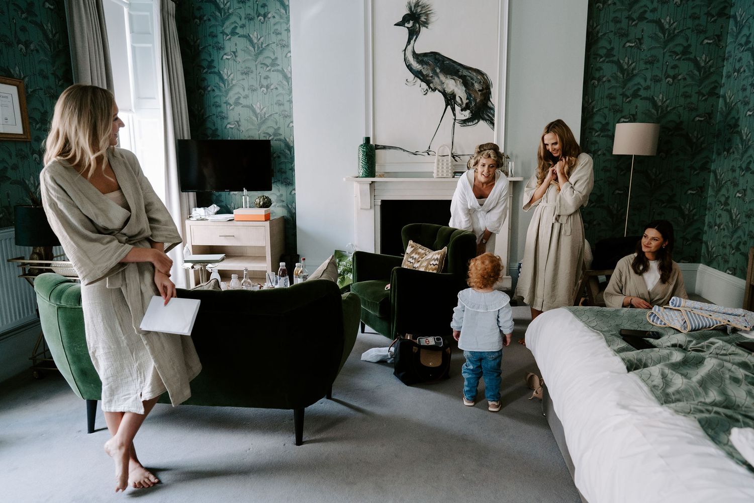 bride and bridesmaids cooing over child at the Queensbury hotel in bath