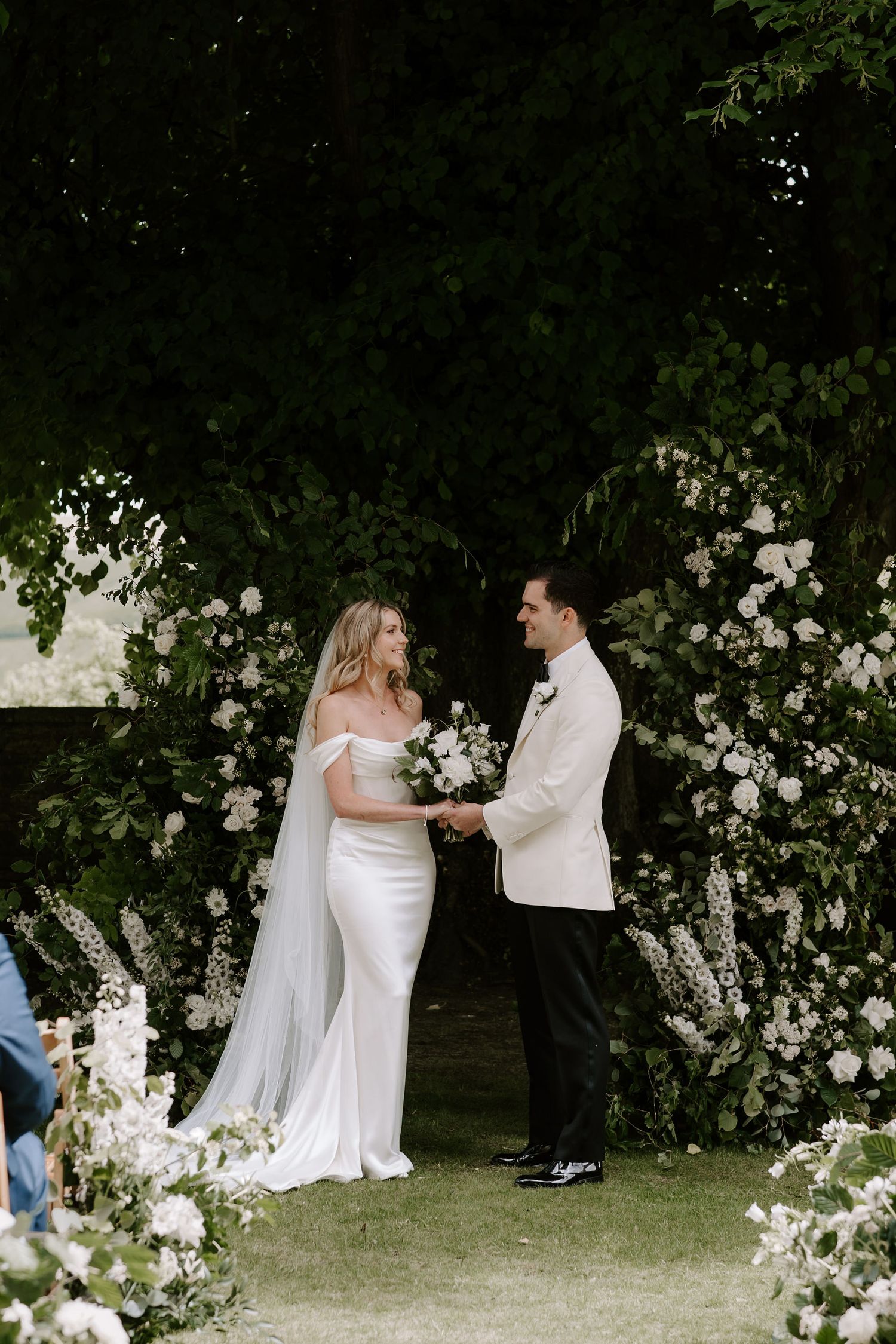 bride and groom holding hands and smiling during ceremony at Hamswell house in bath