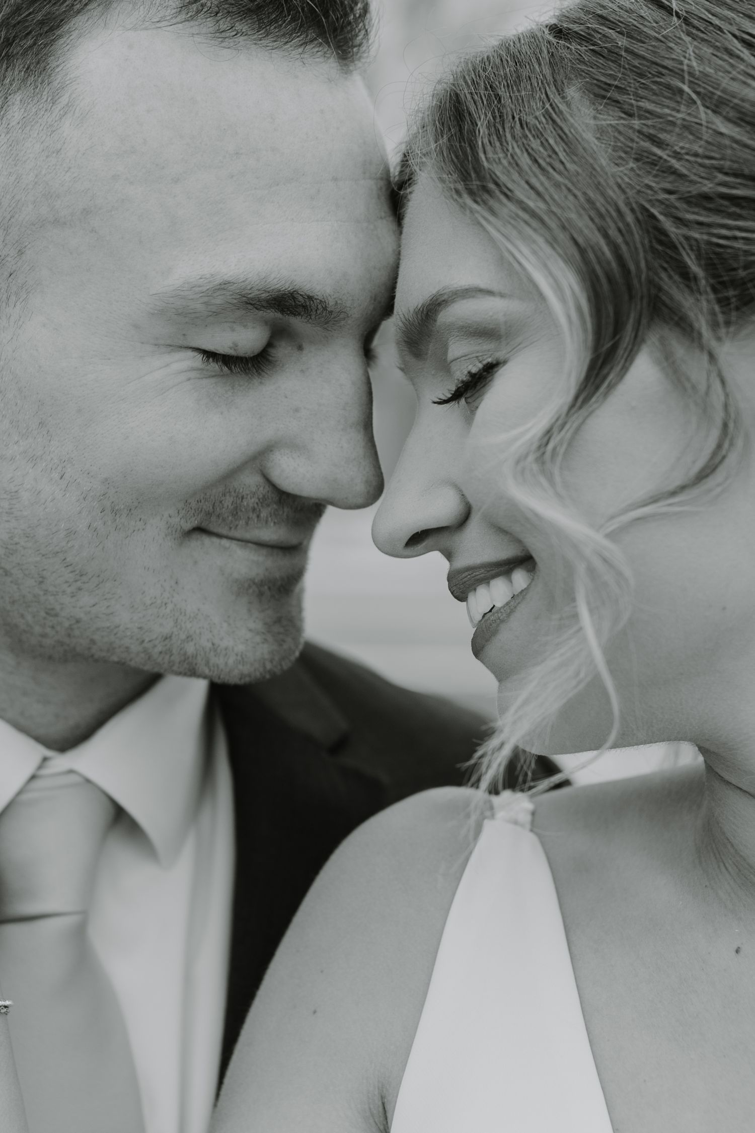A romantic black and white photo series showing an intimate couple embracing in close-up shots.