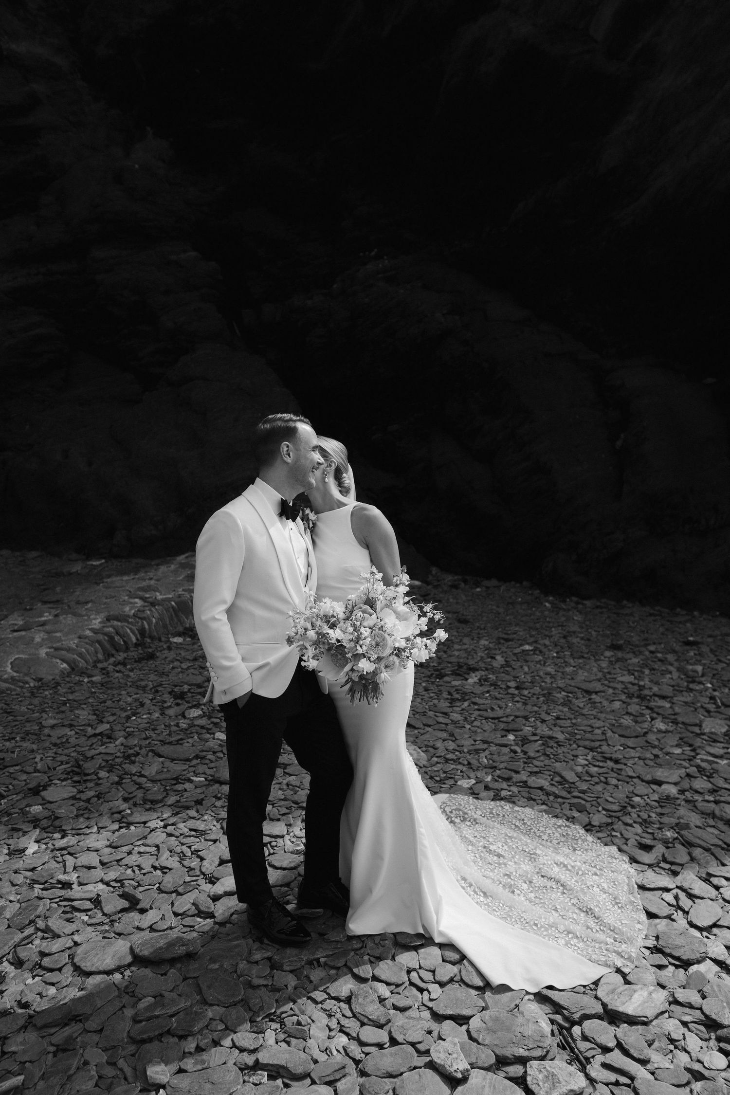 Bride and Groom relaxing on beach at Tunnels beach wedding venue in north devon
