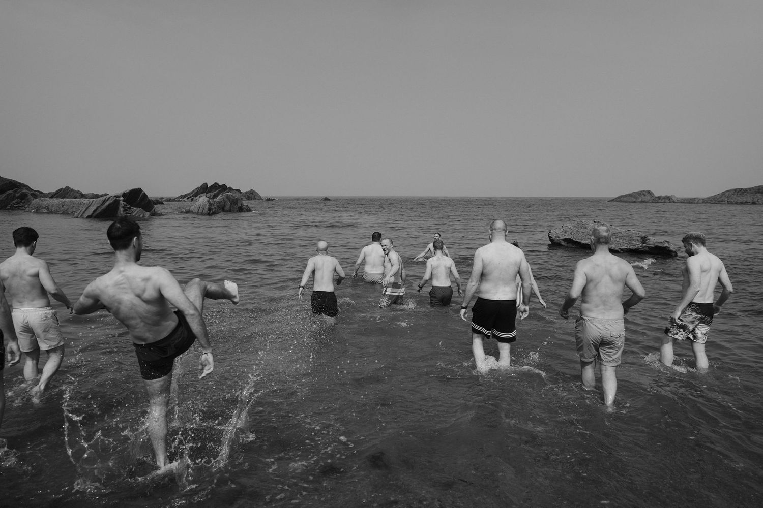 Groomsmen on morning of the wedding at tunnels beach wedding venue in north Devon, going for a morning swim in the sea
