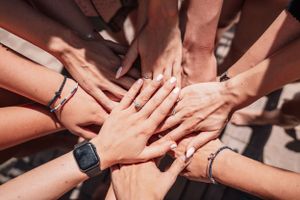 Hands joining together in unity at a celebratory gathering.