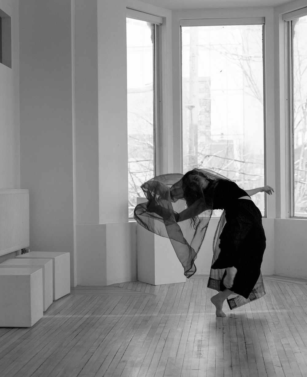 Dramatic black and white photo of dancer bending backwards in contemporary movement.
