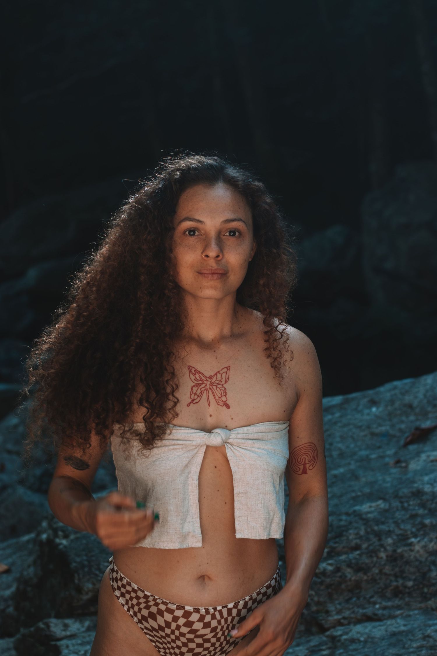 Model with curly hair and tattoos
