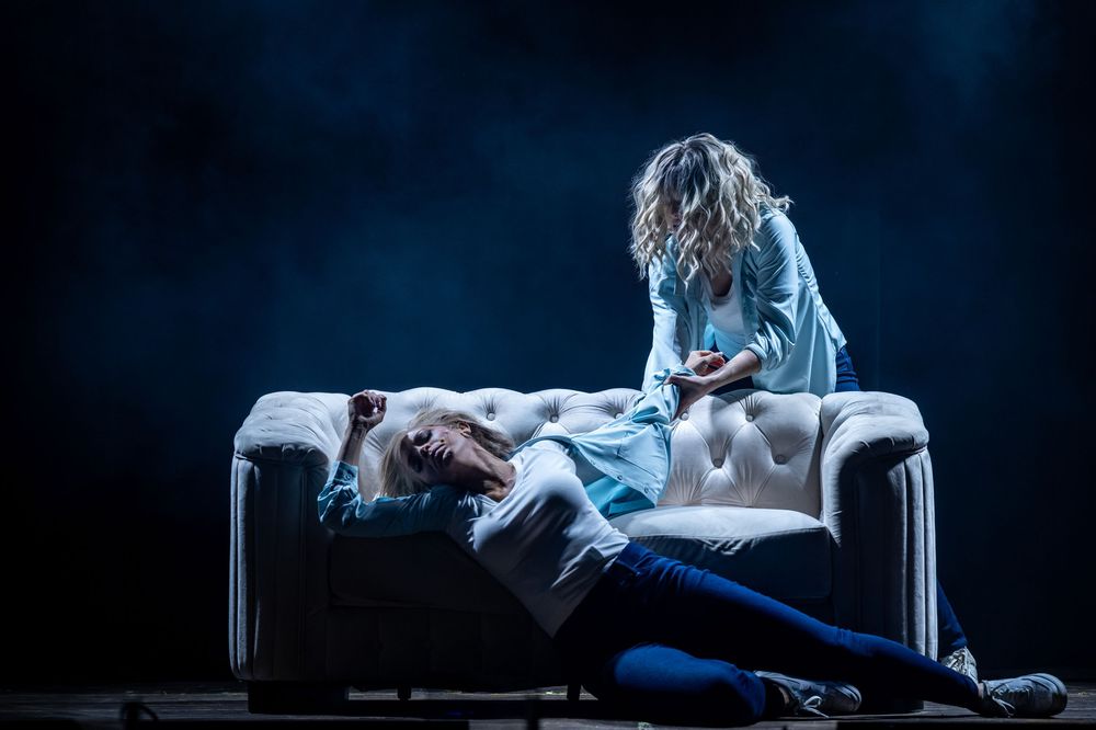 A dramatic sequence of dance poses performed on chairs against a dark background with moody blue lighting.