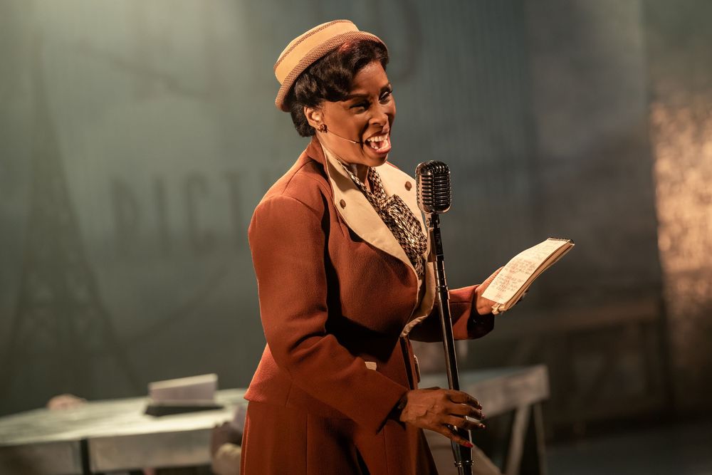 A performer in vintage 1940s attire sings at a classic microphone on stage, holding sheet music.