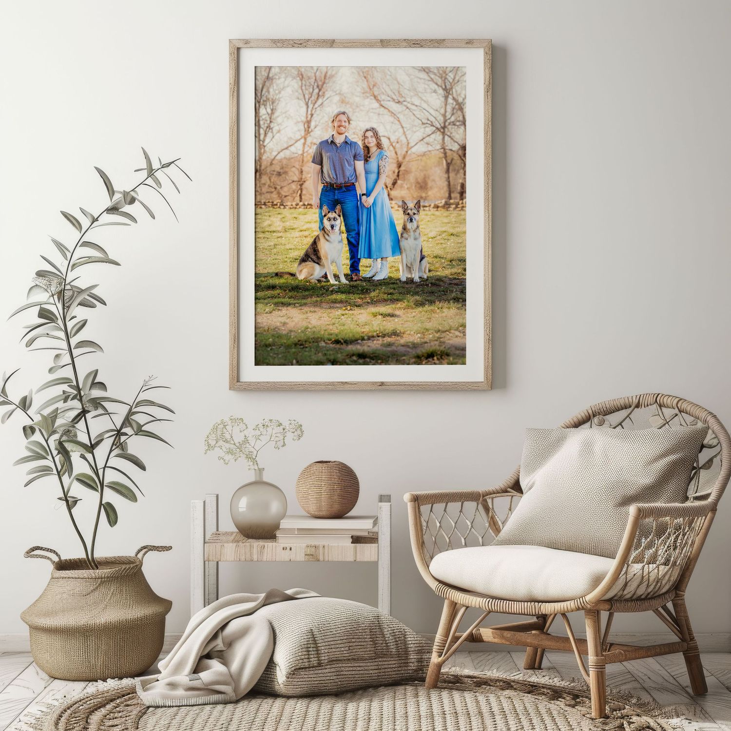 Framed family portrait with two people and dogs displayed above a console table in a bright, neutral living room in Fort Worth, TX.
