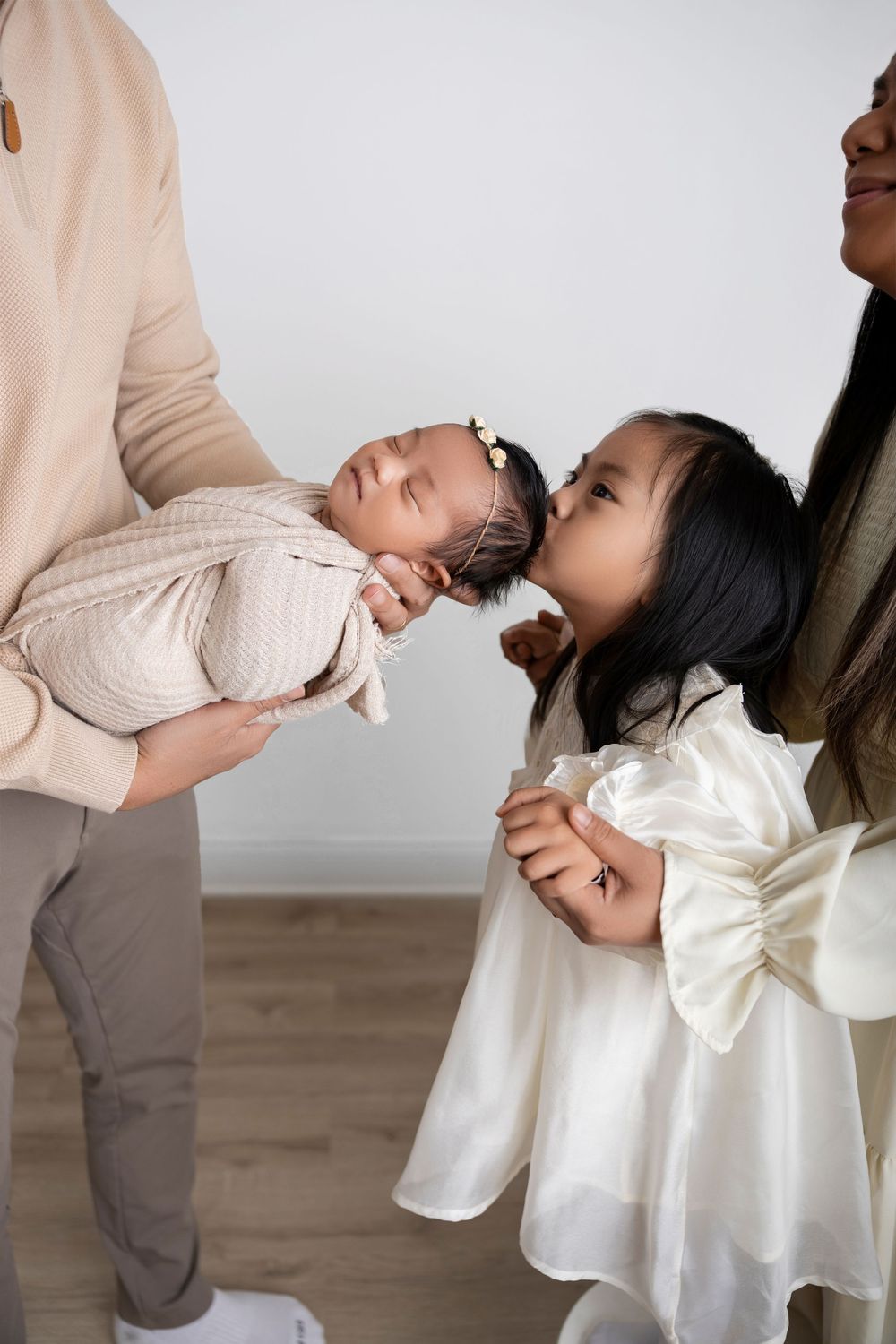 newborn baby held by parents during a family photo session. Morris County NJ Newborn Photographer