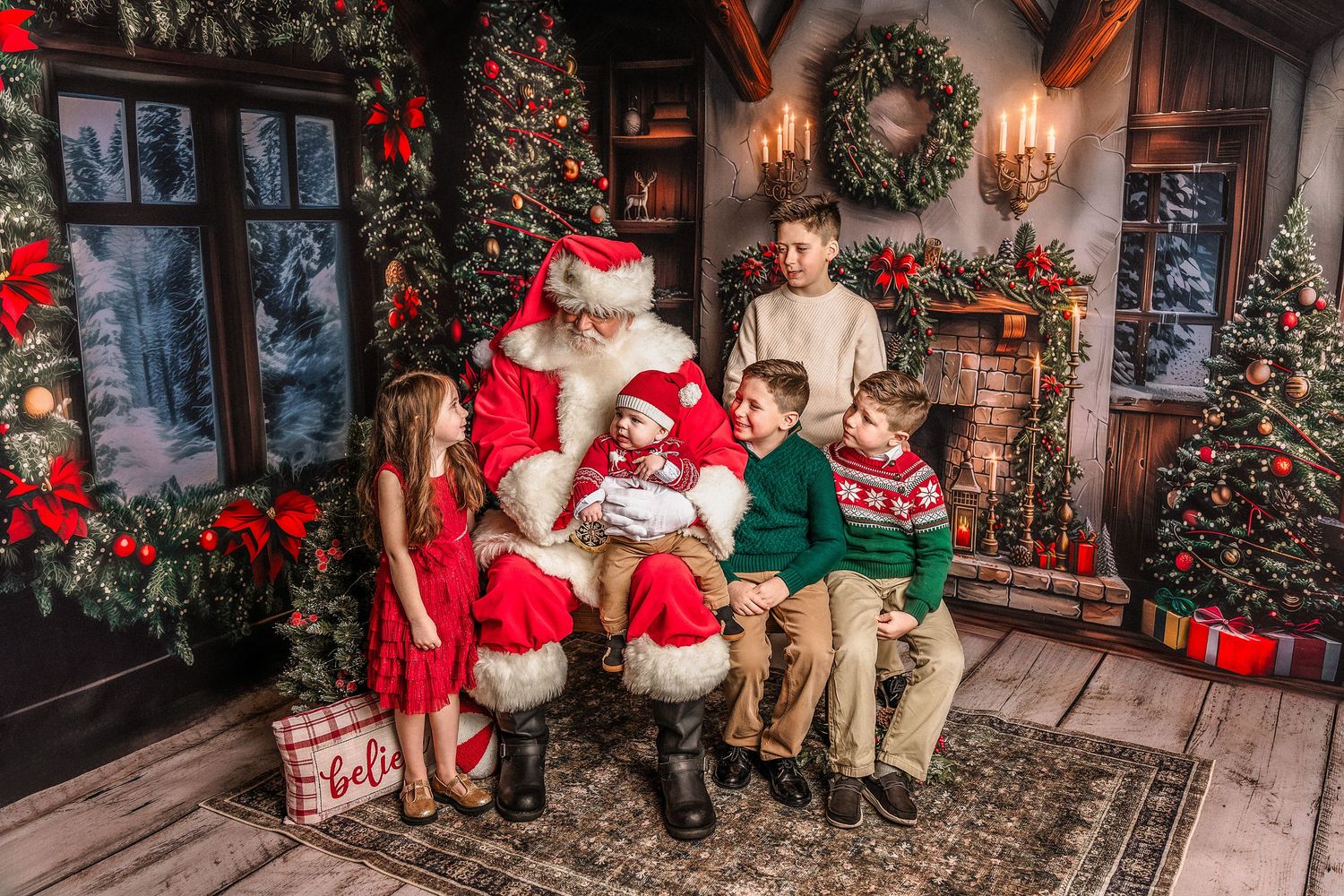 Family with four children posing with Santa Claus in a festive Christmas decorated room with trees and fireplace.
