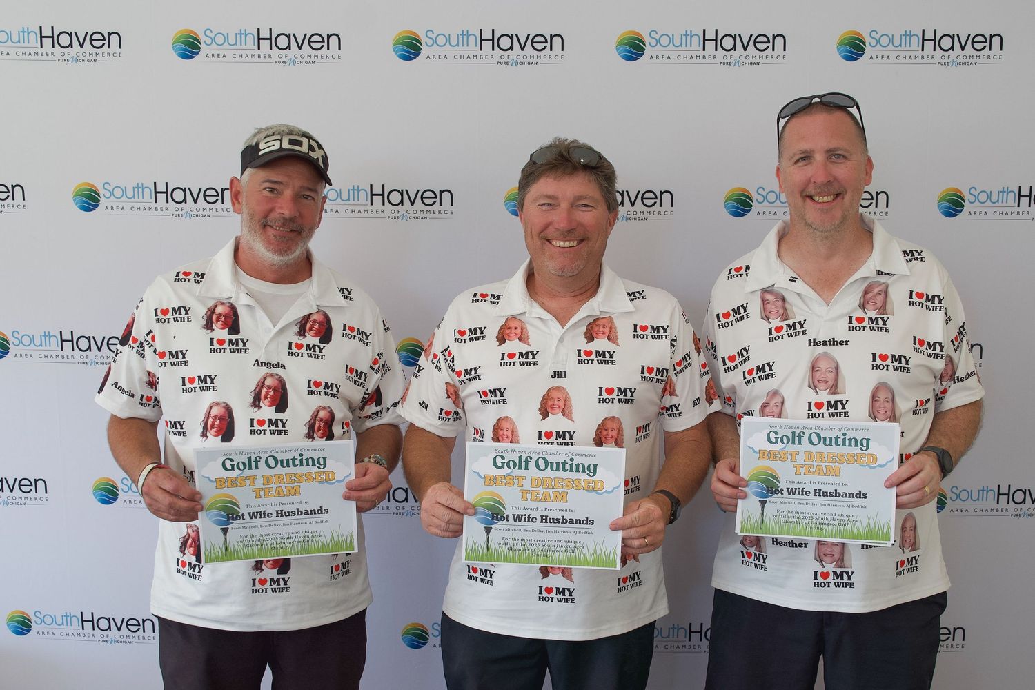 Three men in matching white golf shirts holding awards at South Haven Golf Outing event.