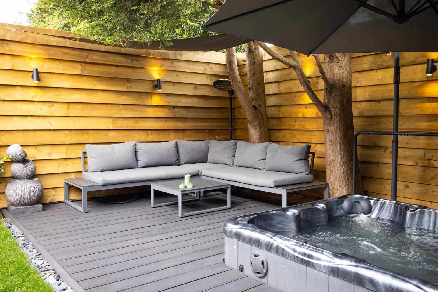 Modern spa patio in Bedfordshire with hot tub, sectional seating and decking, photographed during exterior property shoot.