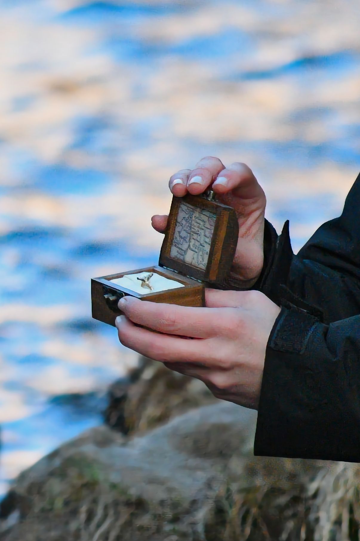 She is presenting the engagement ring to her, asking for her hand in marriage. Pixcapades | The Rocky Mountain Proposal Photographer