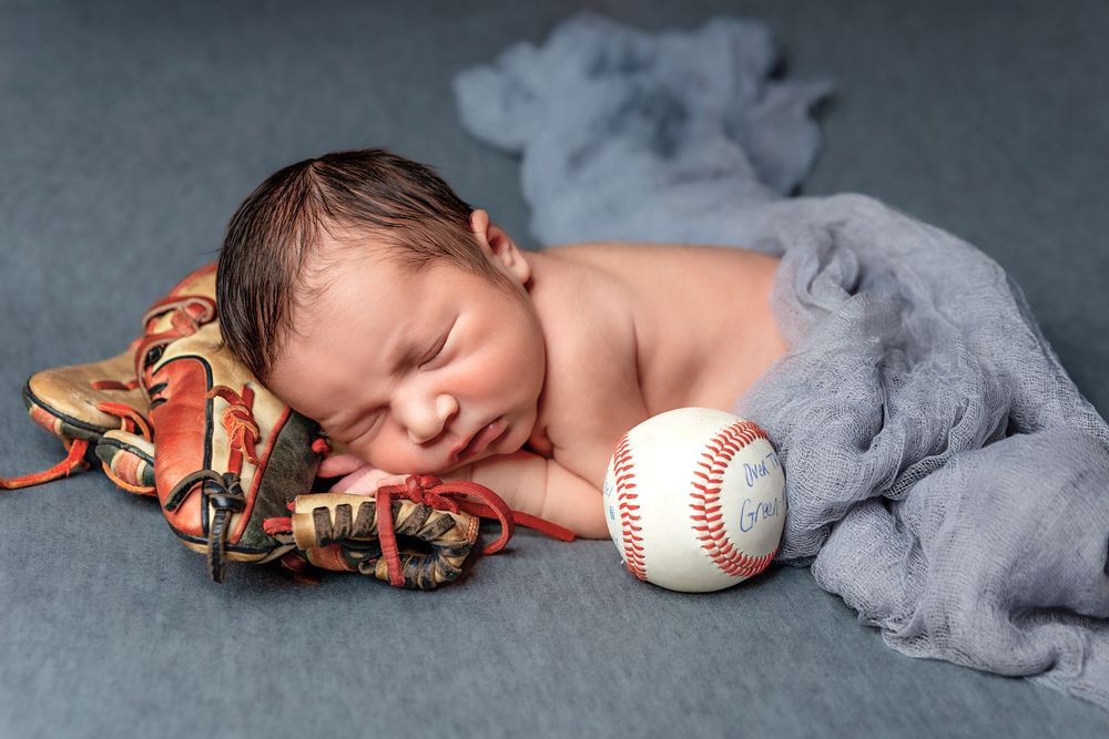 Newborn baby sleeping peacefully on a soft blanket in a Fresno, CA studio.