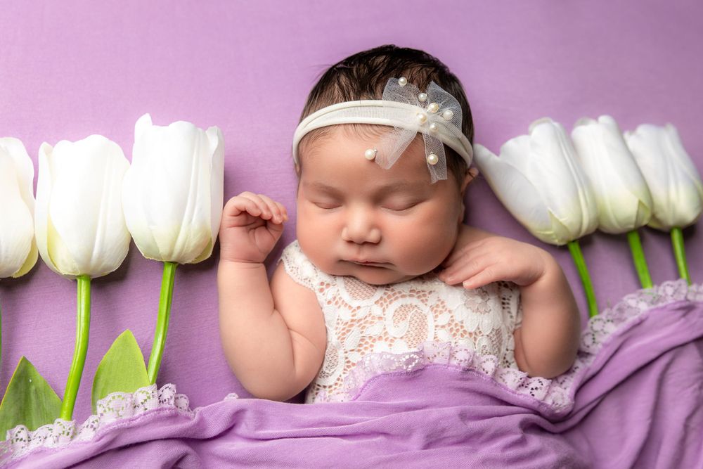 sweet sleeping baby captured in the surrounding flowers in Fresno,ca