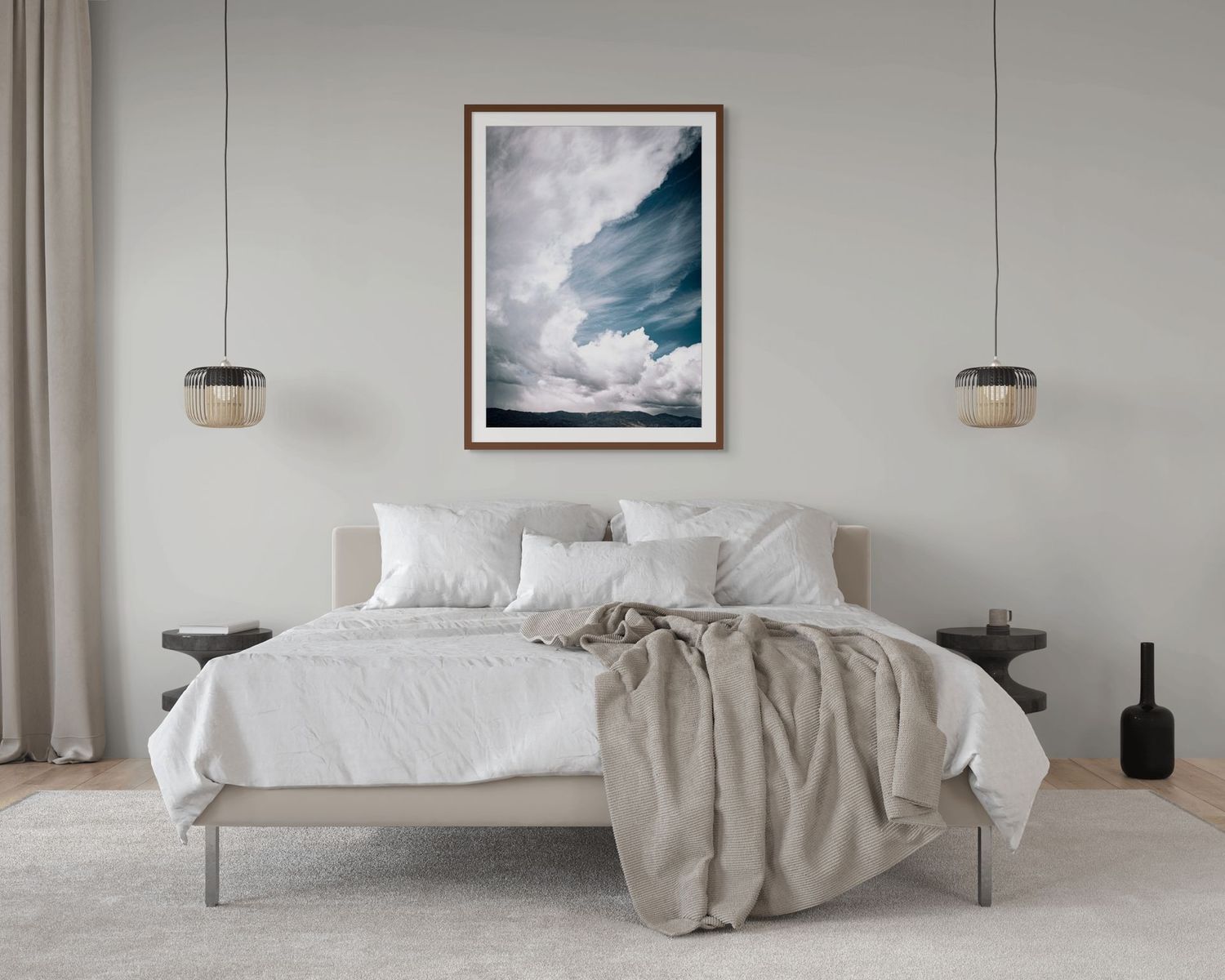 A serene bedroom with a white bed, framed cloud artwork, pendant lights, and neutral tones creating a calm, minimalist aesthetic.
