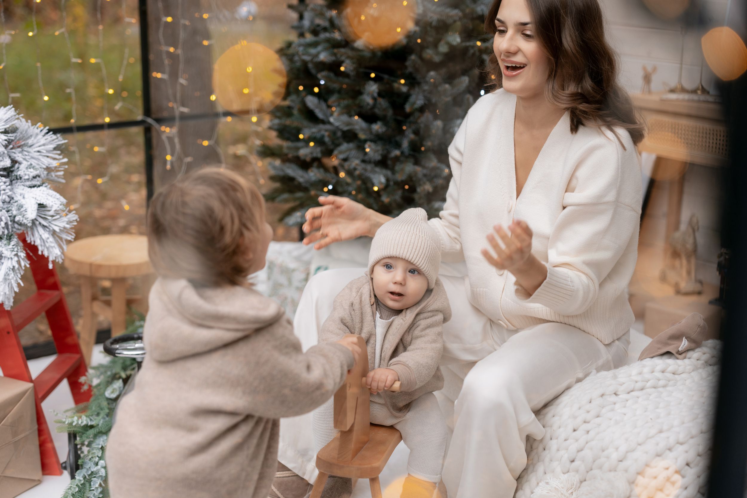 A joyful holiday scene with Christmas decorations and winter white attire.