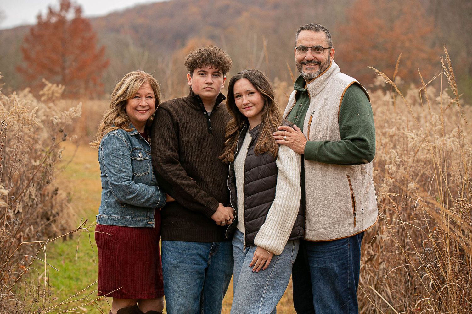 Candid family portraits taken outdoors during golden hour in autumn setting.