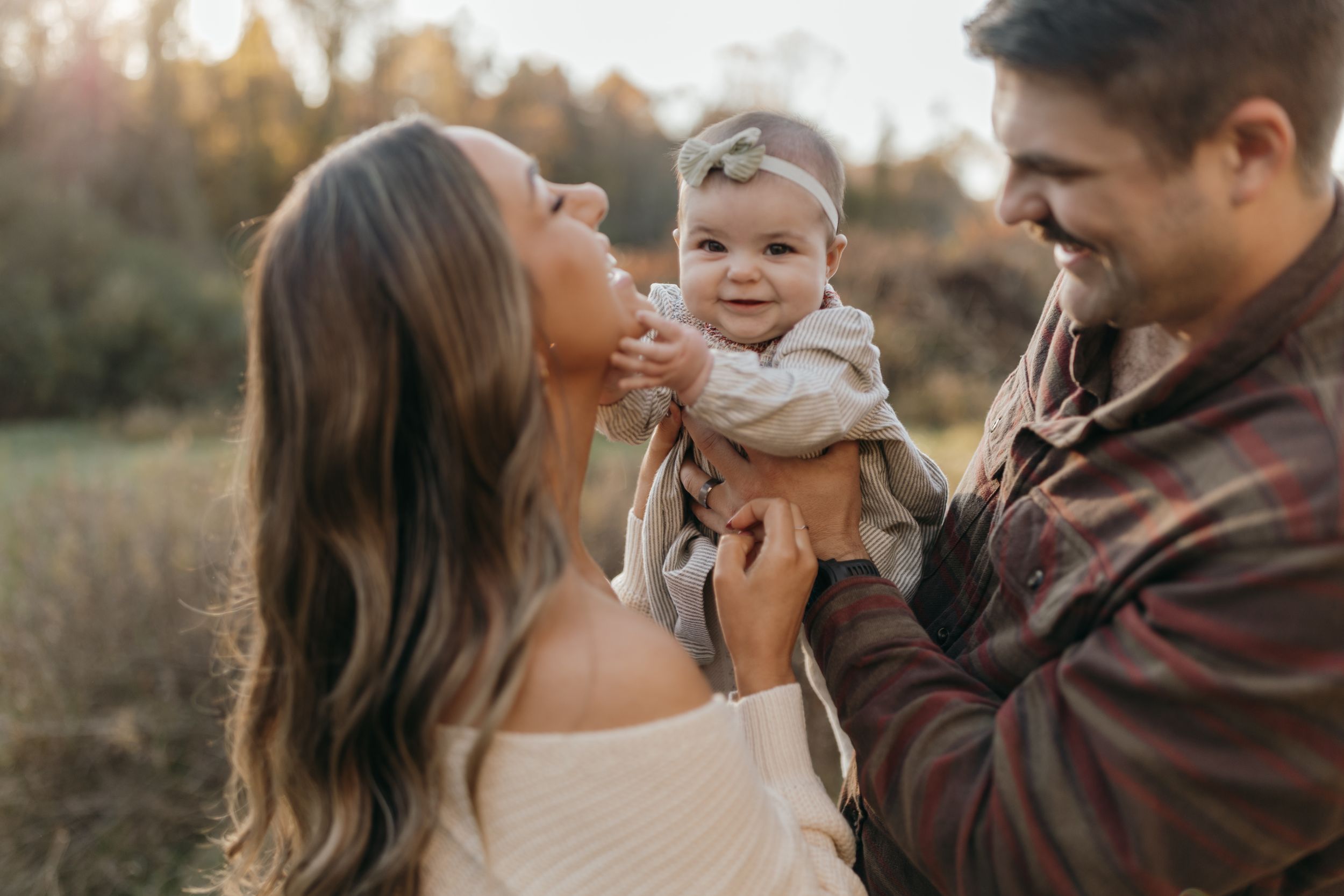 Happy family moment captured during sunset in a field.