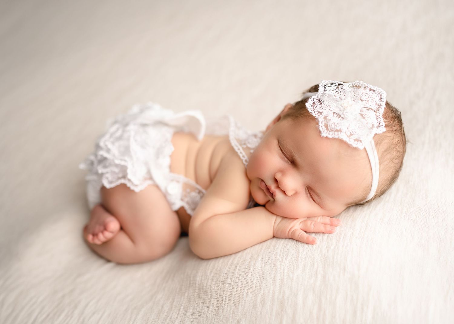 baby girl in lace on backdrop during session with Raleigh Newborn Photographer