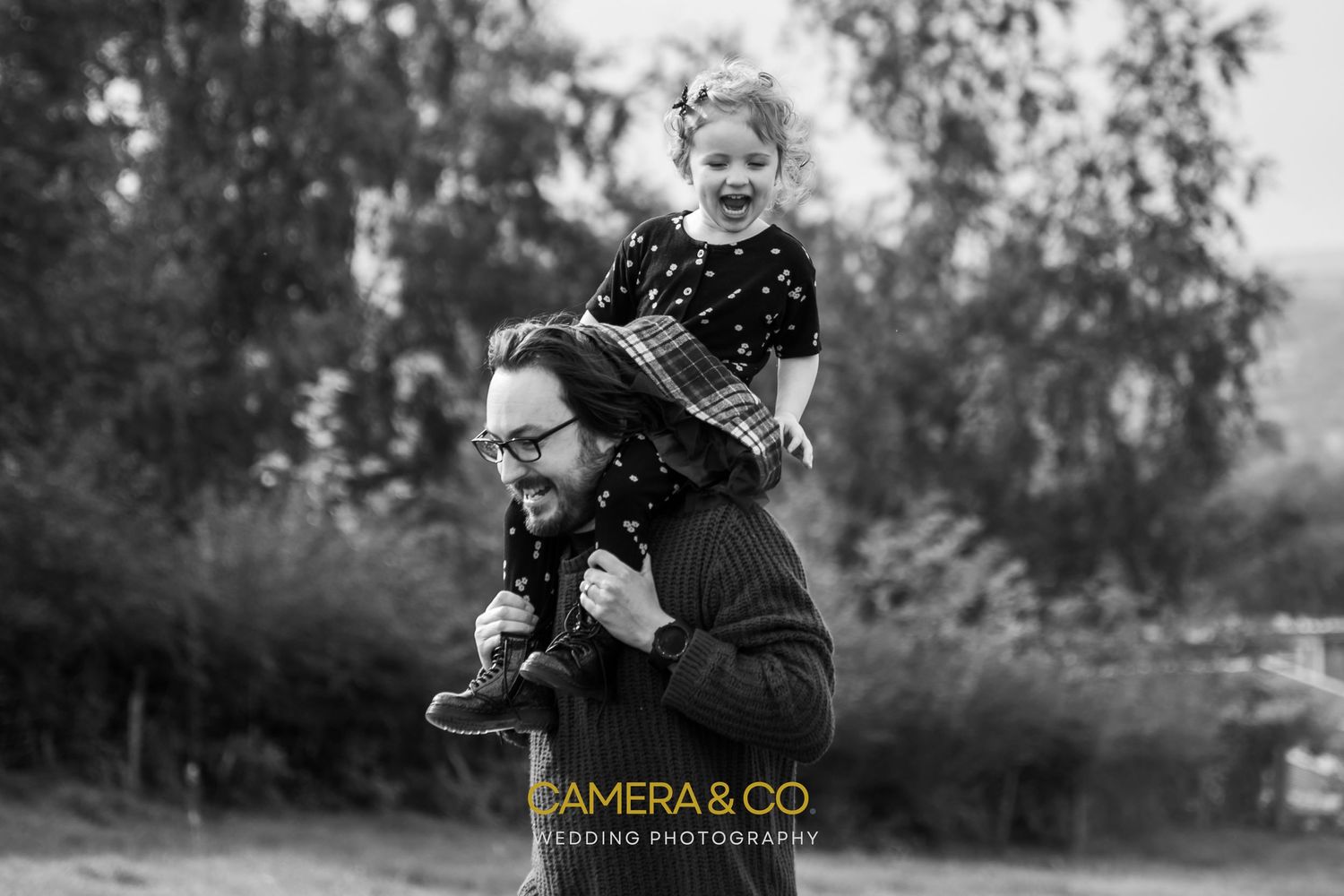 Black and white outdoor lifestyle photography with natural lighting and bokeh effect.