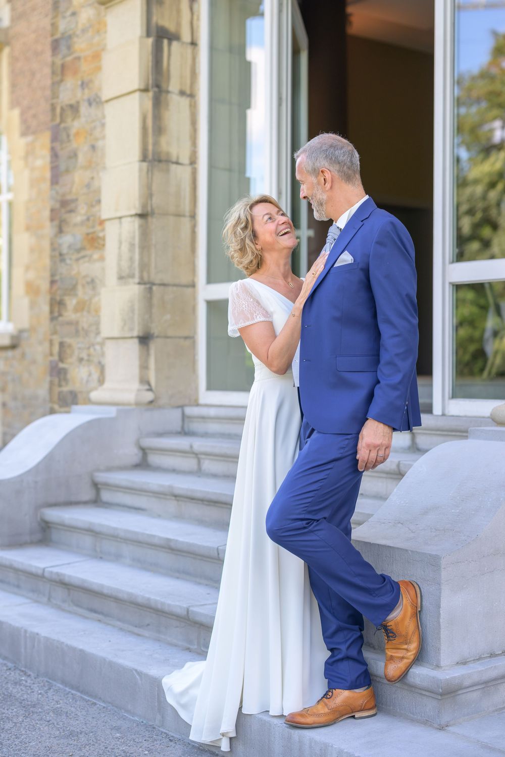 A romantic wedding couple shares sweet moments on stone steps outside a historic building in a photo sequence.
