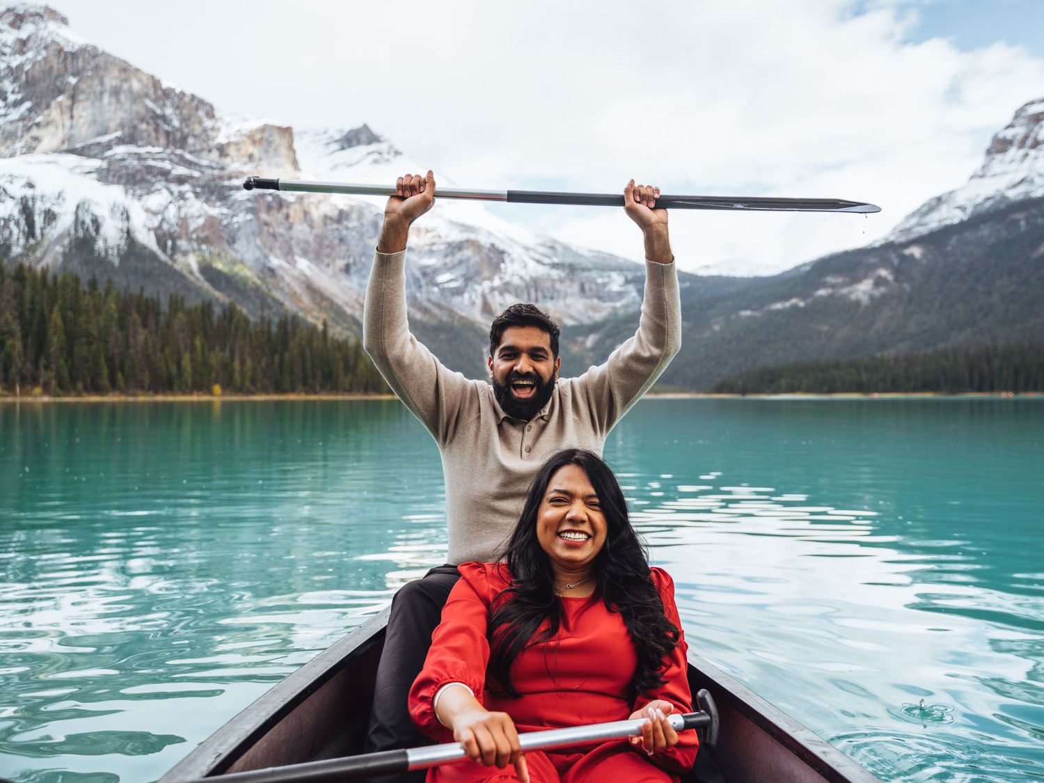 Couple celebrates in a canoe on Emerald Lake. Banff couples photography.