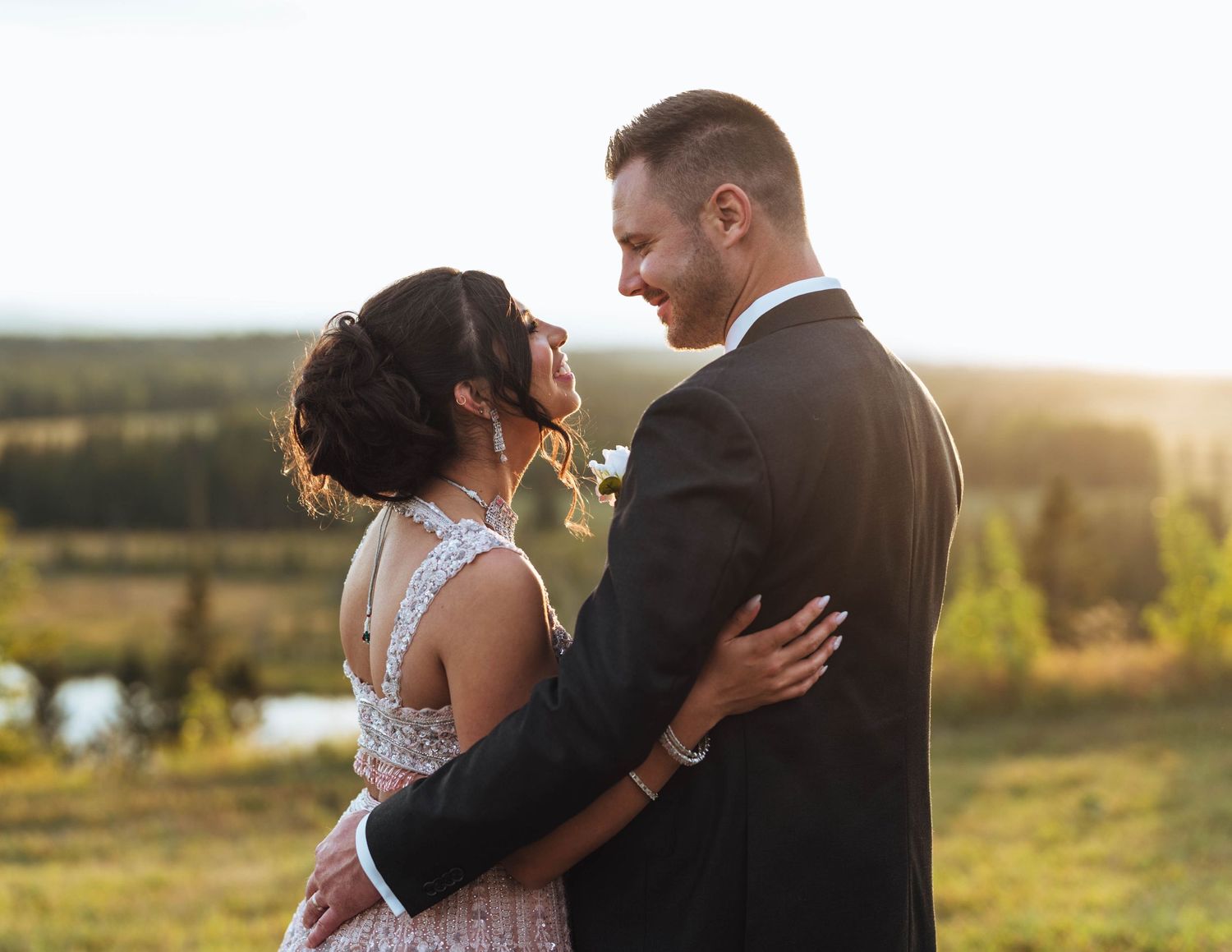 Bride and groom gaze at each other in the sunset. Wedding photography near Calgary.
