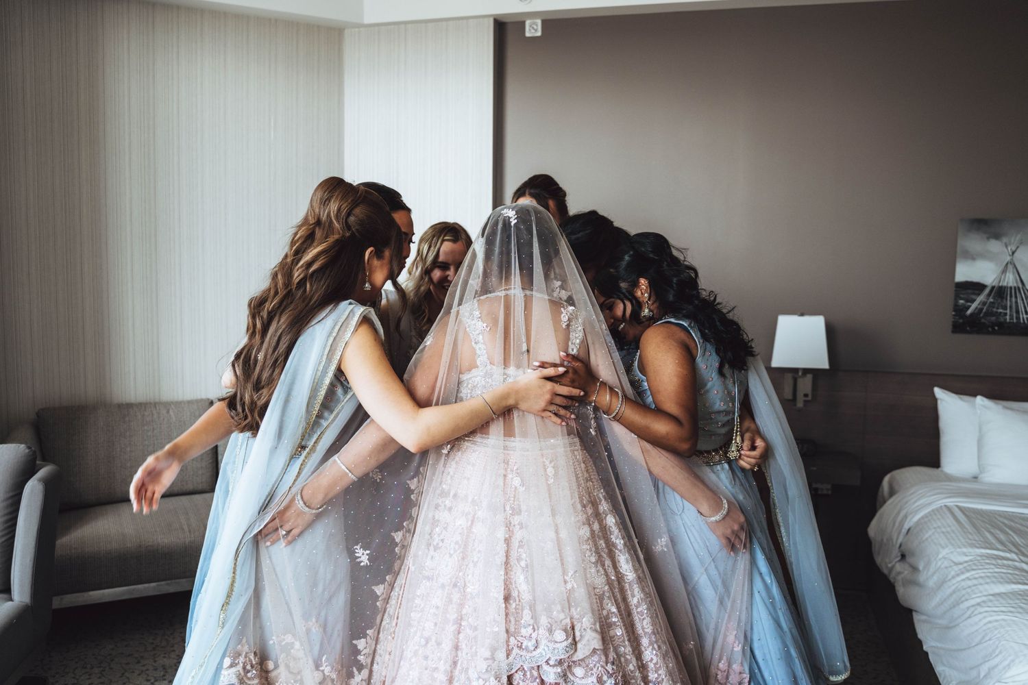 Bride surrounded by bridesmaids, pre-wedding. Calgary wedding prep.