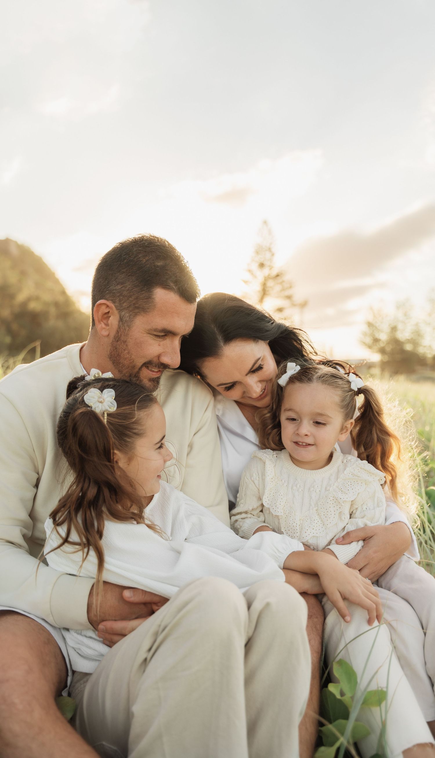 Family Cuddled in close during a beach sunset shoot on the Gold Coast