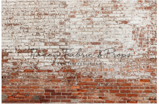 Weathered red brick wall with faded white paint showing traces of vintage text or signage.