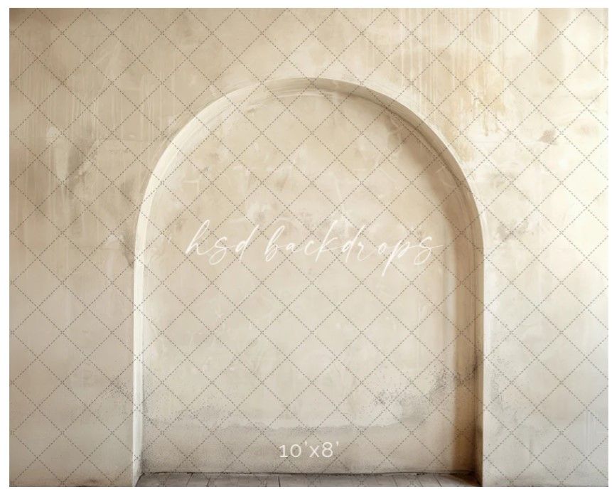 Minimalist architectural arch with textured pattern on cream colored wall.
