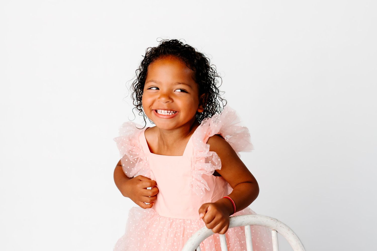 Broken Arrow white indoor studio milestone princess; smiling four-year-old wearing pink dress