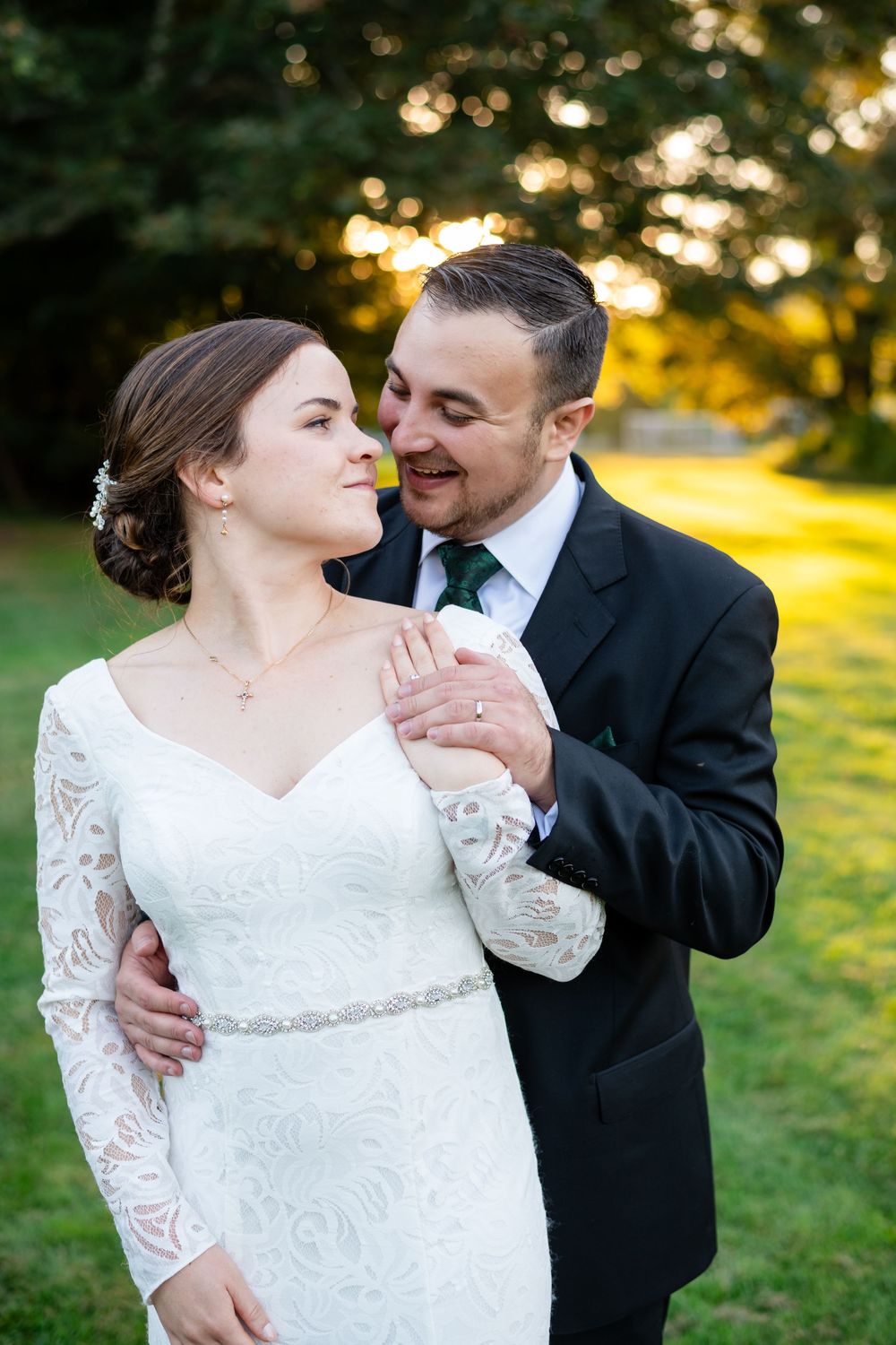 Bride and groom embracing during golden-hour wedding portraits outdoors at Pierce House in Lincoln, Massachusetts