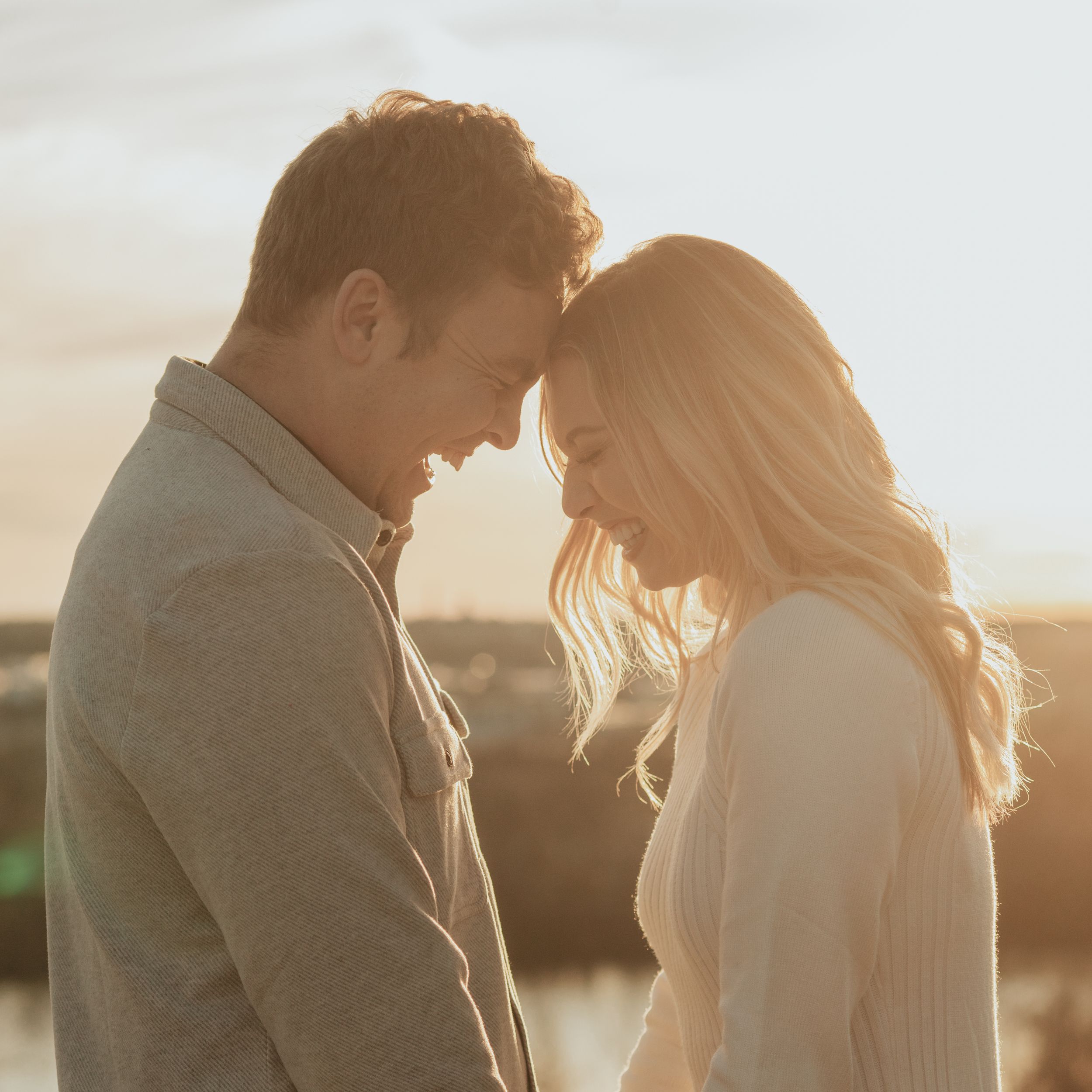 Intimate moment shared between couple during golden hour photoshoot.