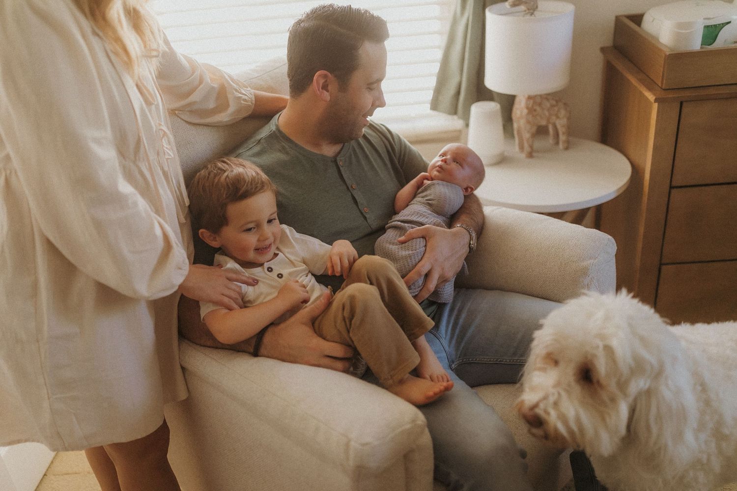 Interior photos showing tender family moments in neutral-toned home setting. San Diego Newborn Photographer.