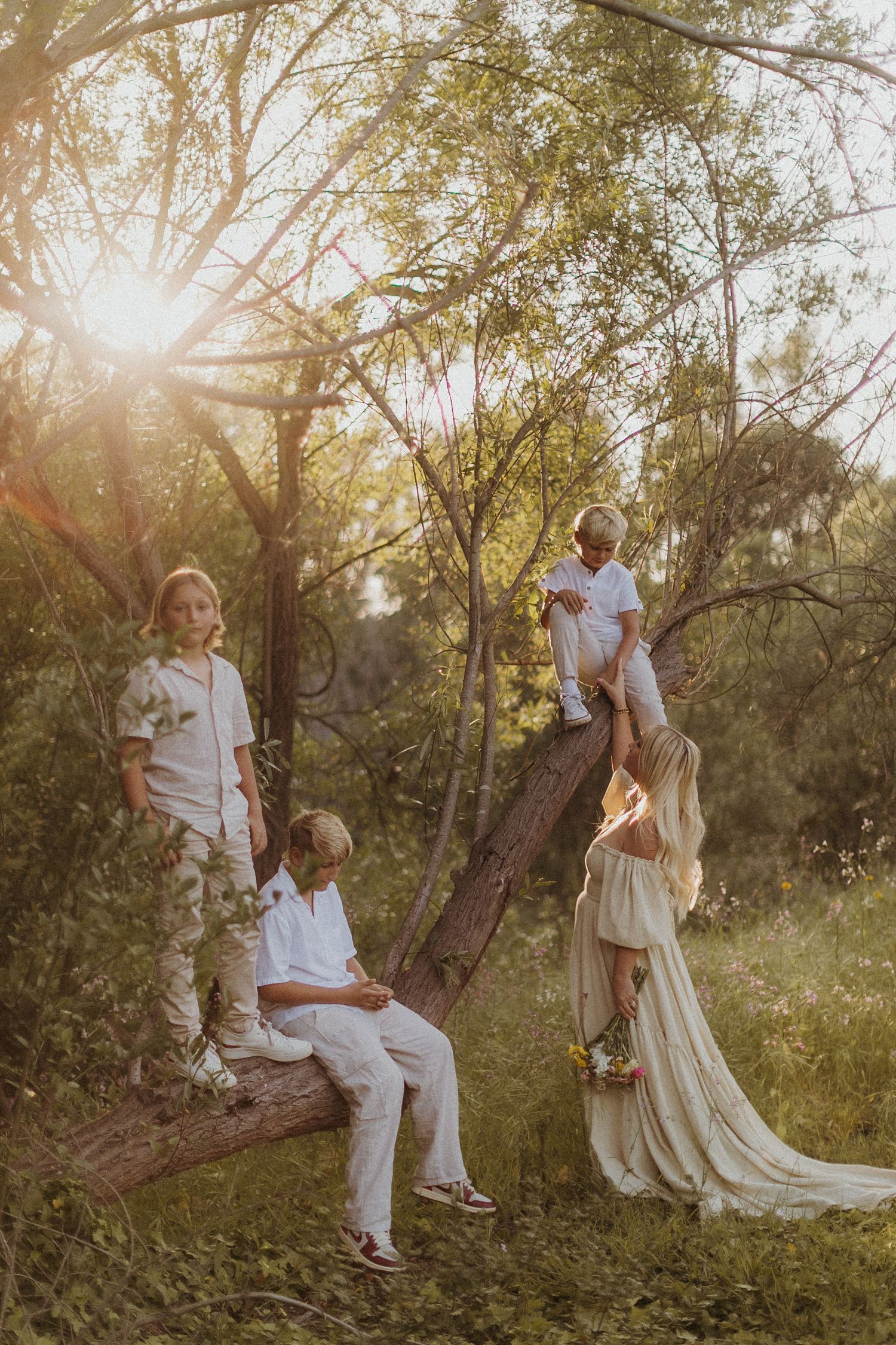 Romantic couple portraits in flowing white dress at golden hour in a natural setting.