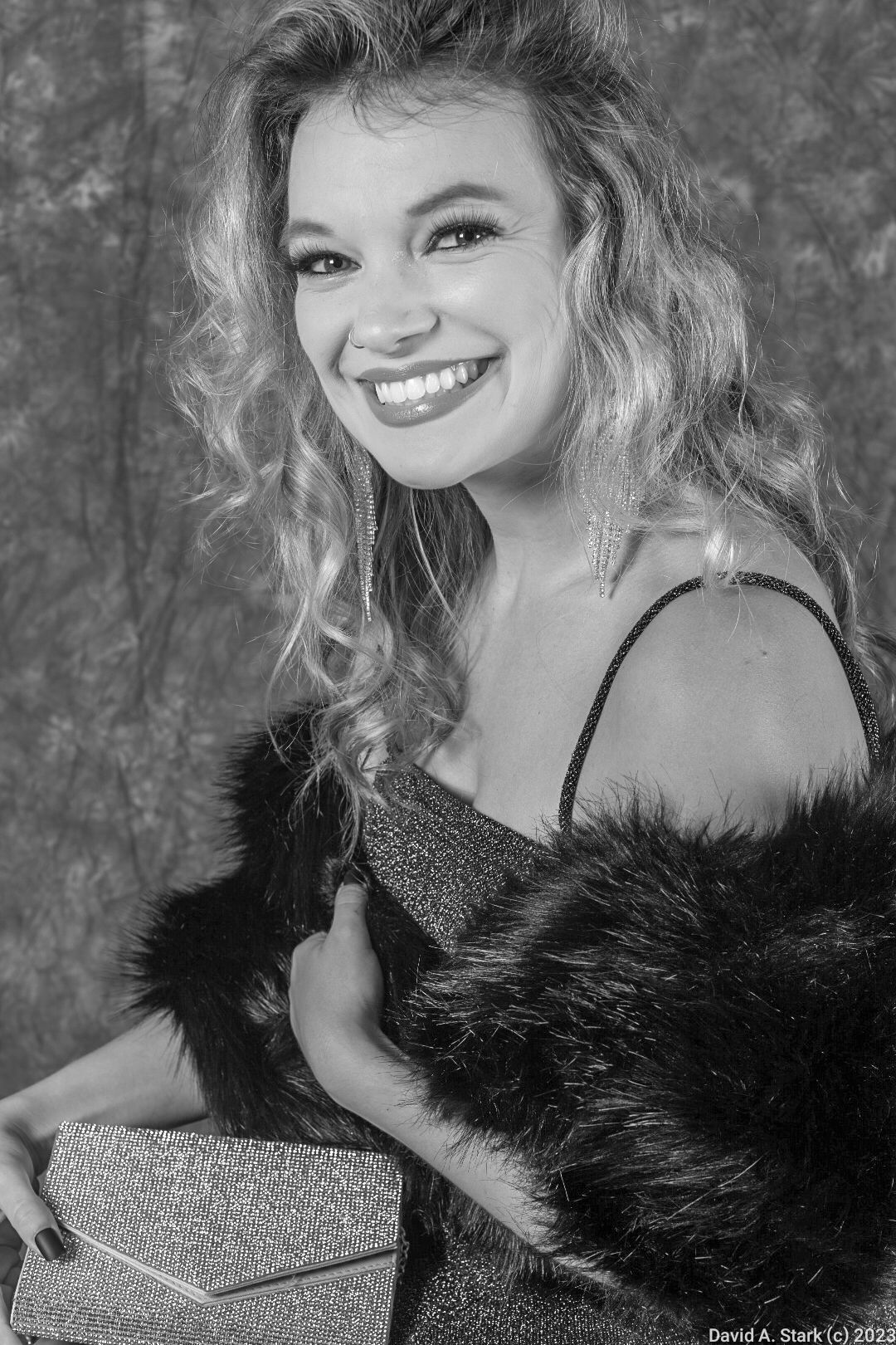 Black and white glamour portrait with fur wrap and sparkly evening clutch.