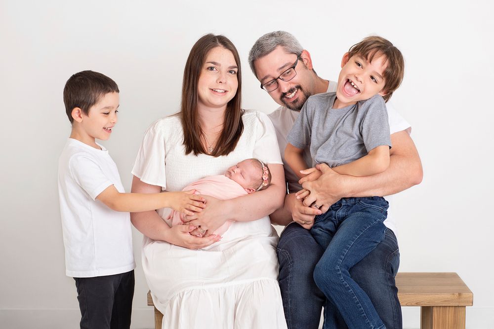 high key family portrait of parents, two young boys and newborn baby sister in studio Baltimore Ontario*
