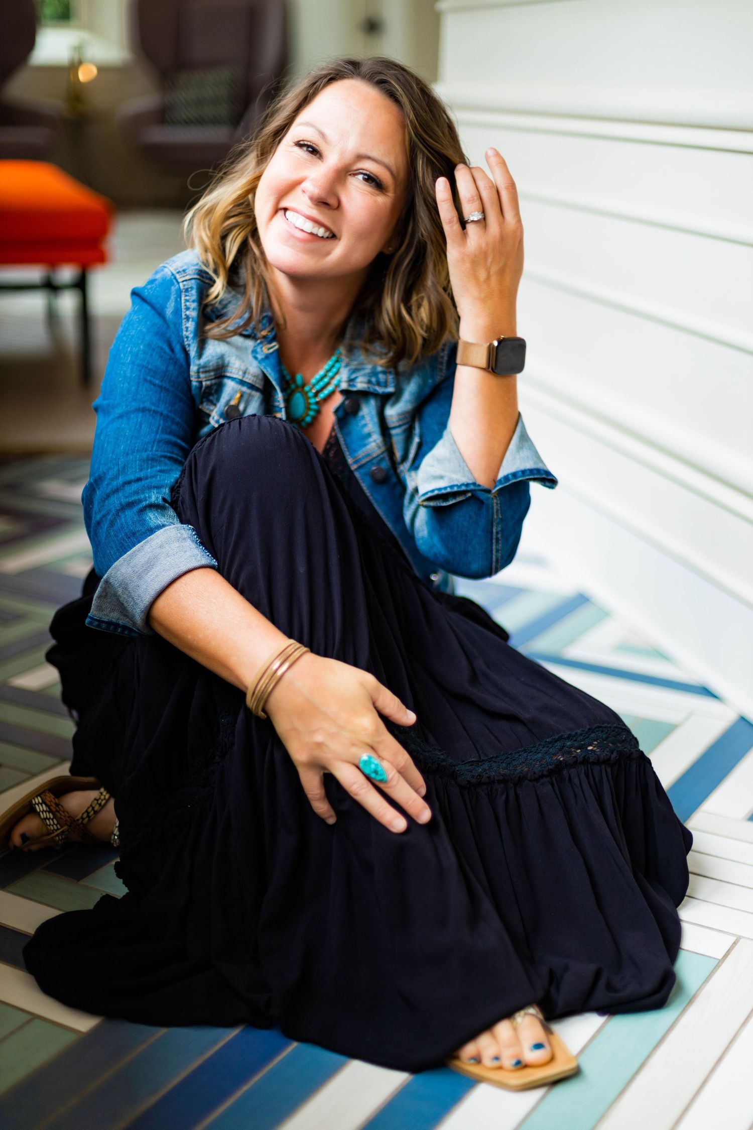 Fashion lifestyle photos featuring polka dot blouse and distressed denim in studio setting.