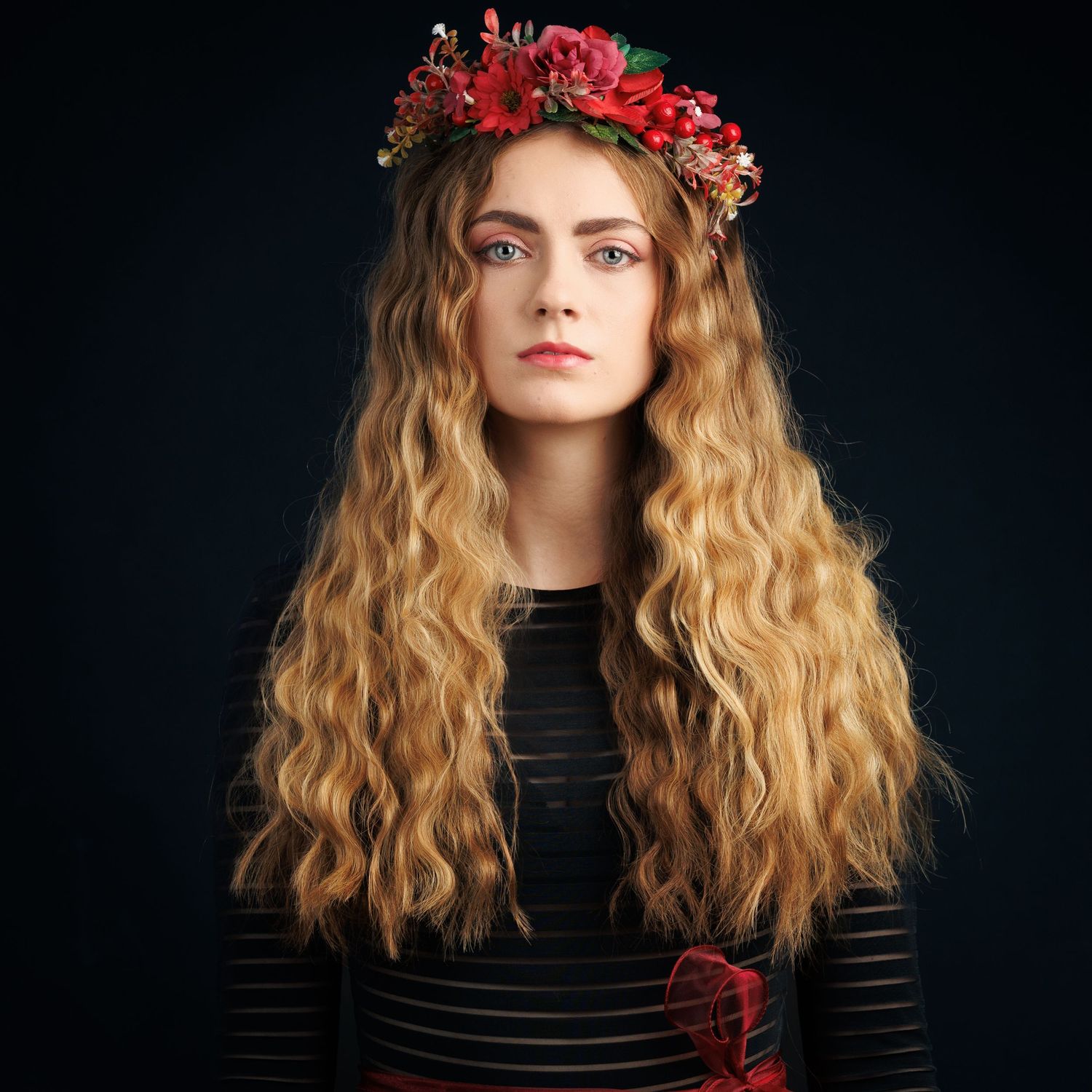Almost Pre-Raphaelite feel with red flower head garland